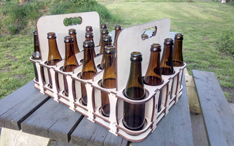 A plywood crate holding twelve brown beer bottles upright in cut circular openings
